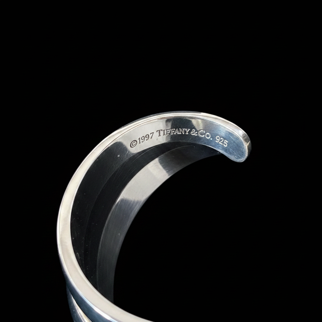Tiffany 1837 wide cuff bracelet interior hallmark detail, black background