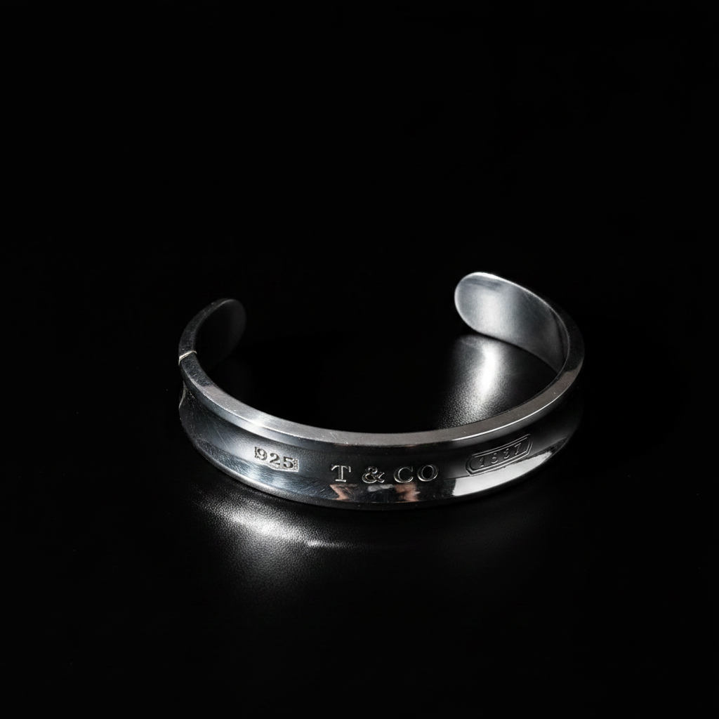 Tiffany 1837 wide cuff bracelet angled three-quarter view, black background