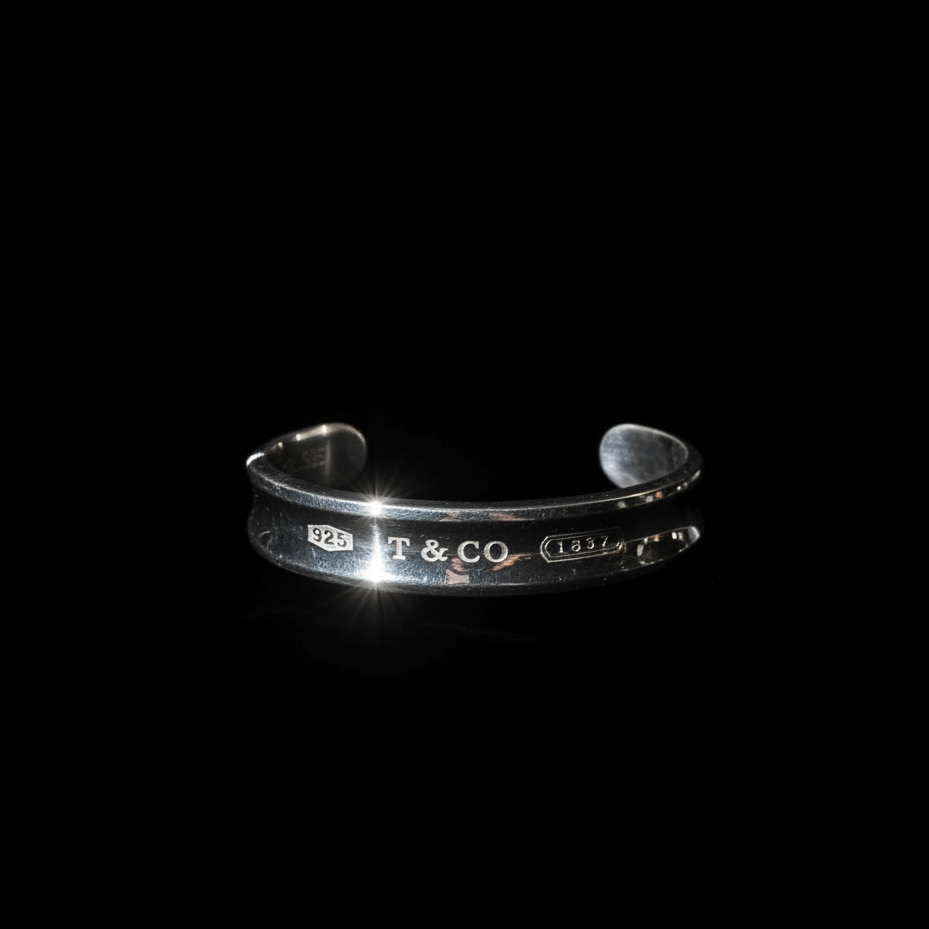 Tiffany 1837 wide cuff bracelet hero shot, engraved exterior, black background