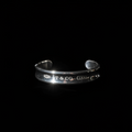 Tiffany 1837 wide cuff bracelet hero shot, engraved exterior, black background